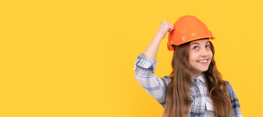 Engineer teenager girl. Funny teen girl in helmet and checkered shirt, build. Child in hard hat...