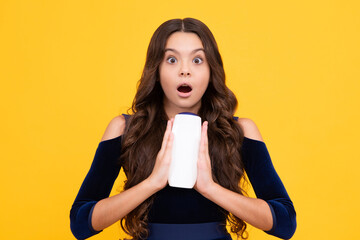 Child with shampoo conditioner. Daily cosmetic care. Teenager kid 12, 13, 14 years old hold bottle of hair and skin care. Beauty health and cosmetics. Surprised teenager girl.