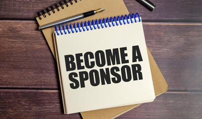 BECOME A SPONSOR text on wooden background