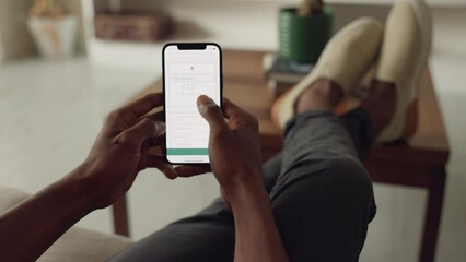 Black man hands, phone and travel booking app for transport flight, hotel hospitality or calendar schedule in house living room. Zoom on planning vacation, trip and location on global ticket website