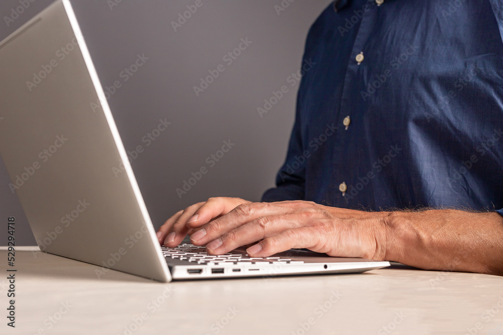 Poster Man hands at laptop keyboard. Male typing email or document text for work or study, surfing Internet while sitting at table with computer. Human chatting with partners, colleagues