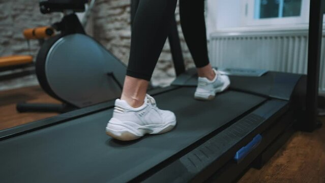 Woman jogging on treadmill at the gym.