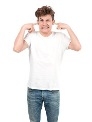 Fototapeta premium Stressed young guy covering his ears with his hands
