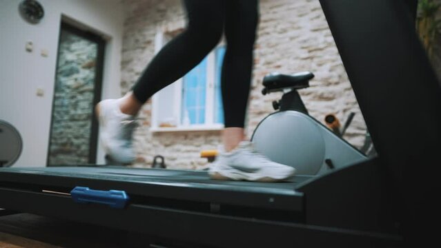 Woman jogging on treadmill at the gym.