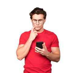Confused young man using a mobile phone