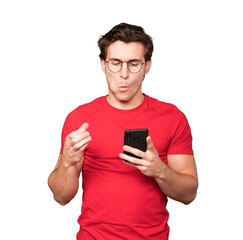 Confused young man using a mobile phone