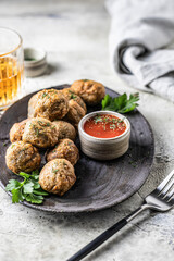 Cibriki are traditional potato fritters made from grated potatoes in balls form. Traditional Belarusian cuisine, served with sauce, herbs and cutlery in modern style. for menu
