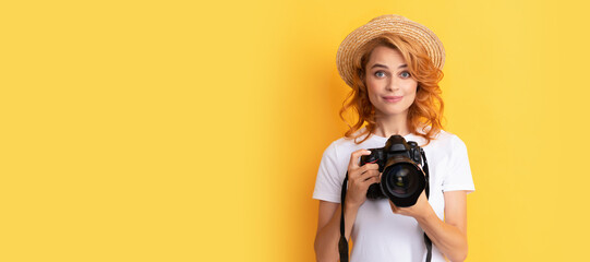 smiling redhead woman photographer with camera in straw hat making photo, photography. Woman isolated face portrait, banner with mock up copy space. - obrazy, fototapety, plakaty