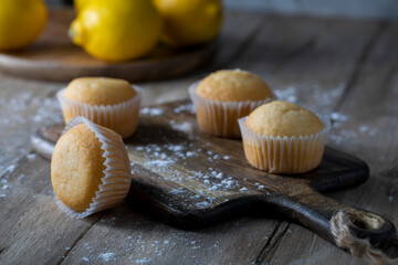 Fresh lemon muffins on wooden table