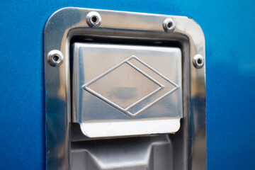 Close up of a metal truck cover. Fuel tank lock on blue truck.