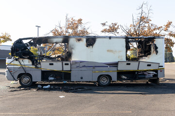 Burned out RV motorhome interior after a fire or explosion or fire bomb or arson shows the melted...