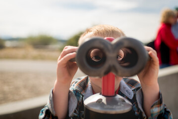 Portrait of boy looking through binoculars