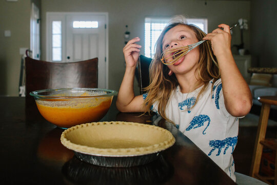 Girl Licking Whisker While Sitting Preparing Tart At Home