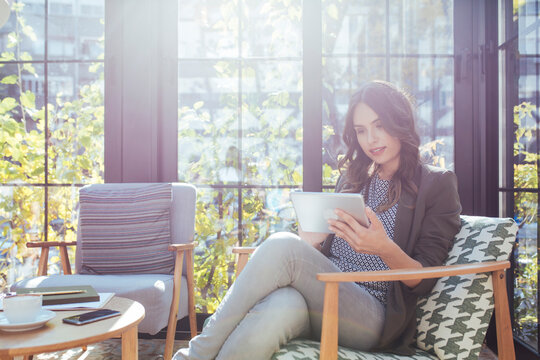 Businesswoman using tablet computer in cafe