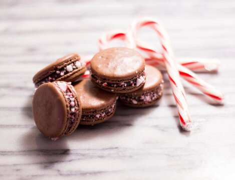 Close-up of macaroons with candy canes on table