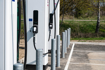 Close up of an electric vehicle charging station on a roadside car park