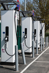 Close up of an electric vehicle charging station on a roadside car park. Vertical picture.