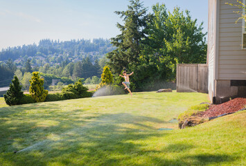Cheerful shirtless boy playing on grassy field against sky in backyard