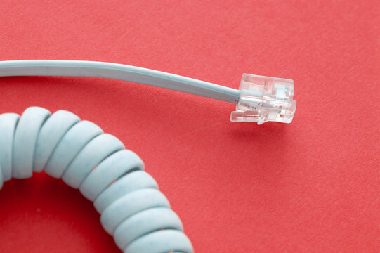 Plug And Coiled White Spiral Cord For A Telephone