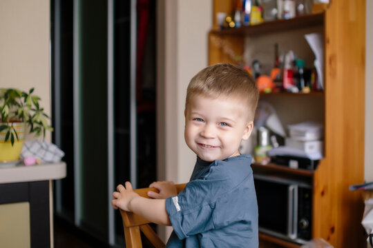 Portrait of happy boy looking over shoulder at home