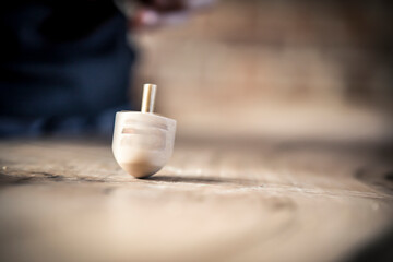 Dreidel spinning on table