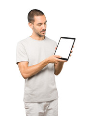 Young man doing gestures using a tablet