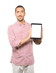 Young man doing gestures using a tablet