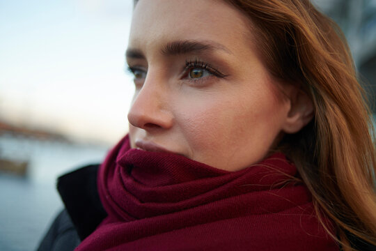 Close-up of thoughtful woman wearing scarf outdoors