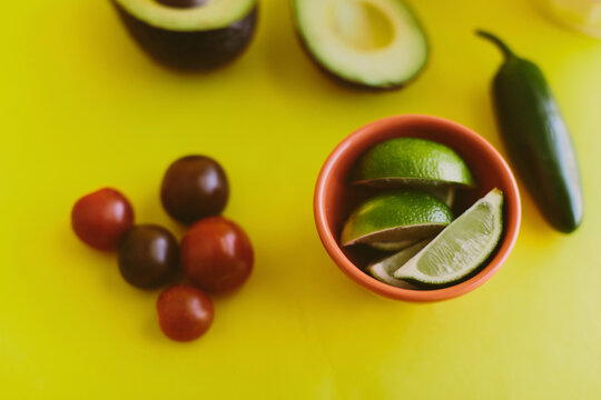 Close-up of salsa ingredients on yellow background