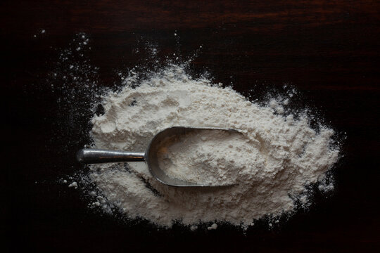 Overhead view of cooking utensil on flour at table