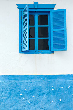 Low angle view of window amidst wall
