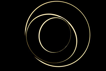 Light rings from chandelier form abstract scientific cosmic corona on black for background or photography overlay for halo effect