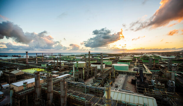 Petrochemical plant against sky during sunset