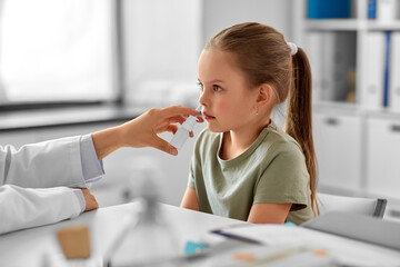 medicine, healthcare and pediatry concept - female doctor or pediatrician and little girl patient...