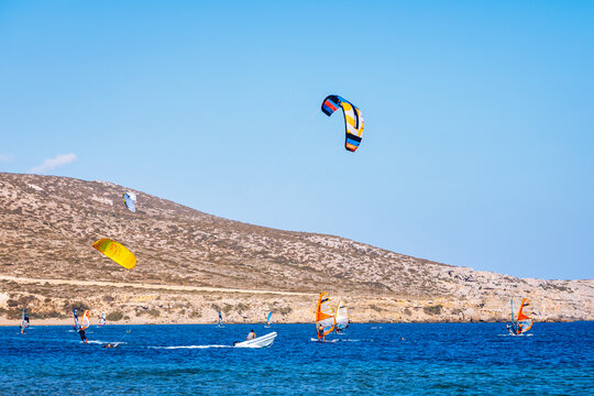 Surfers in Prasonisi Beach in Rhodes island, Greece. Kiteboarder kitesurfer athlete performing kitesurfing kiteboarding tricks. Prasonisi Beach is popular location for surfing. Greece