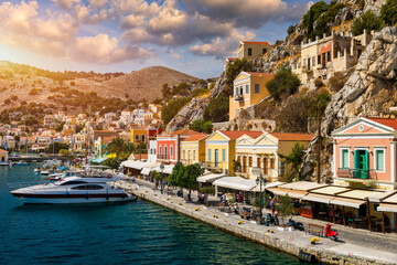 View on Symi (Simi) island harbor port, classical ship yachts, houses on island hills, Aegean Sea...