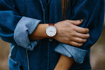 Midsection of woman wearing denim shirt while standing outdoors