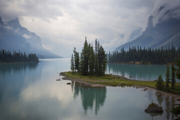 Scenic view of lake by mountains against cloudy sky at Banff National Park