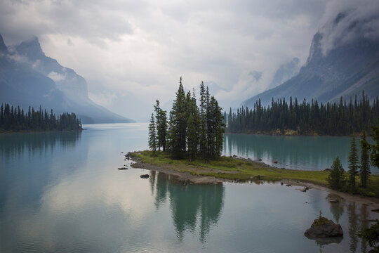 Scenic view of lake by mountains against cloudy sky at Banff National Park