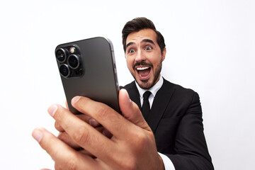 Business man himself on the phone taking a selfie with a smile with teeth happy communicating via video call online in a business suit on a white isolated background close-up on a wide angle lens