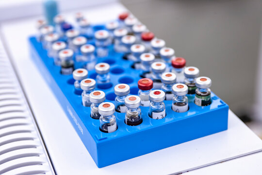 High angle view of vials in blue tray on table at process laboratory