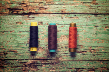 Overhead view of colorful threads on old wooden table