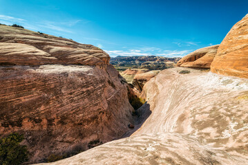 Scenic view of mountains against blue sky during sunny day at Canyonlands National Park