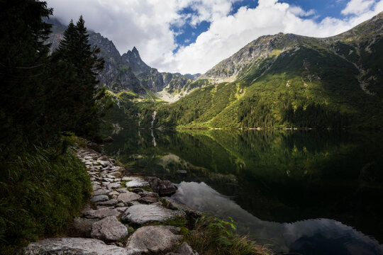 Scenic view of Morskie Oko lake against Tatra Mountains in forest