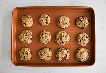 Sheet pan of freshly baked chocolate chip cookies shot from above
