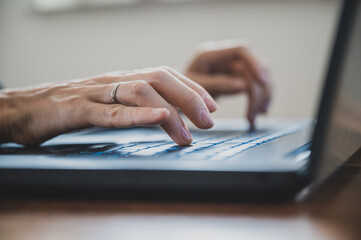 Female hands using laptop computer