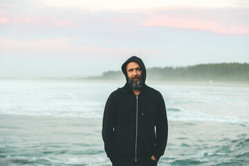 skeptical expression on mans face by ocean