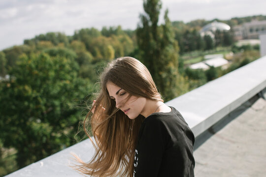 woman on the roof straightens hair