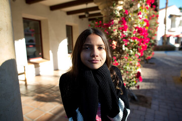 Portrait of a girl in a sweater flowers in the background
