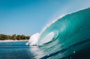 Wave breaking on a paradisiacal beach in Indonesia